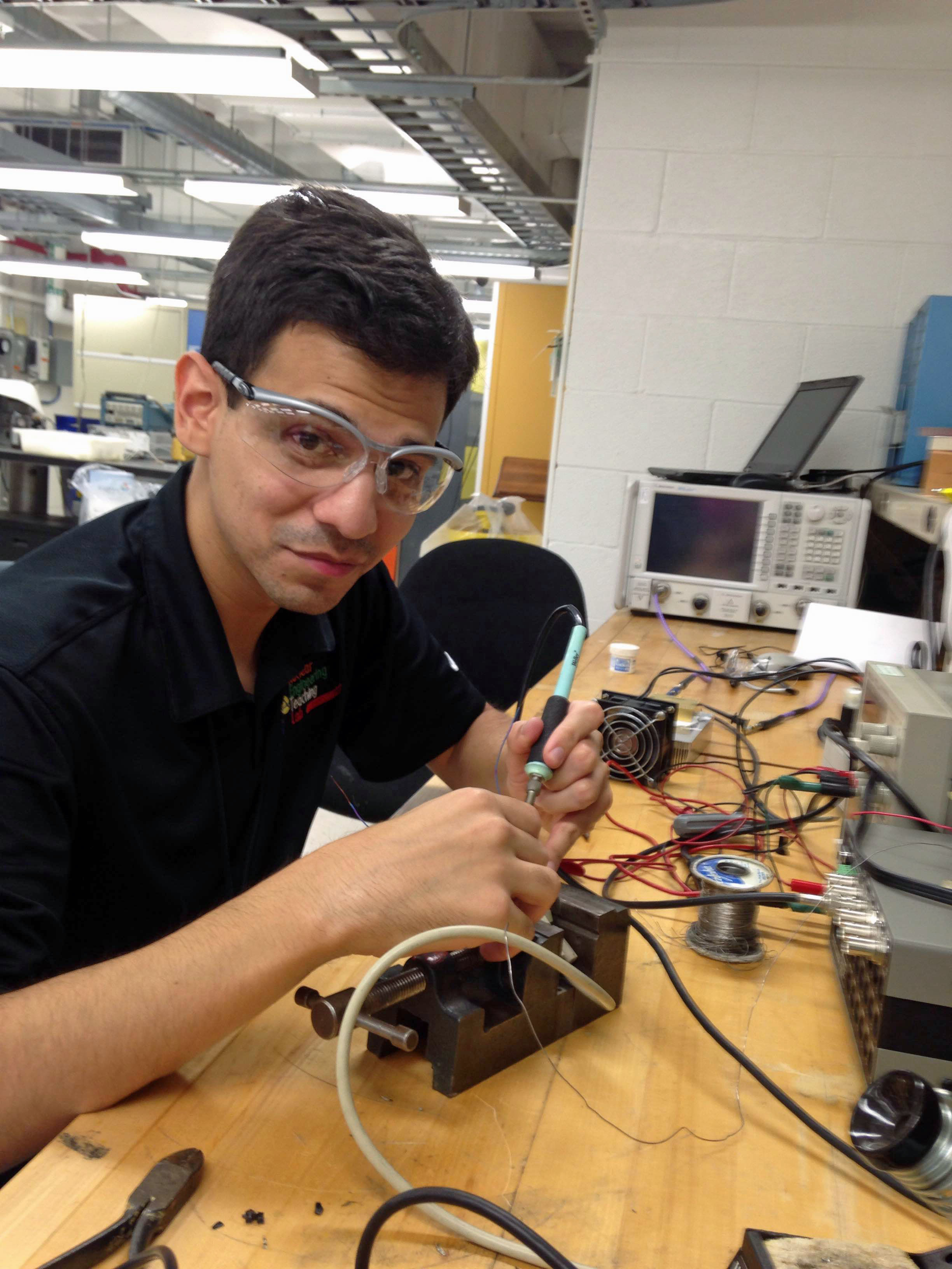 student wearing safety goggles working on project